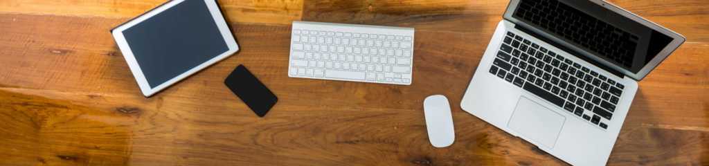 devices that cause digital eye strain laid out on a wood desk