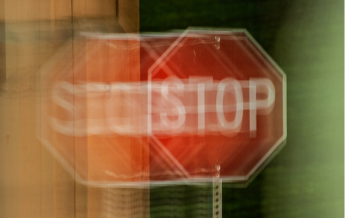 POV of double vision seeing red stop sign